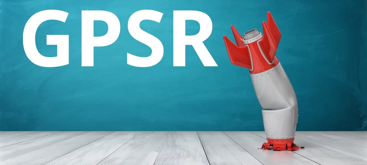 Grafik zur EU-Produktsicherheitsverordnung (GPSR): Eine humorvolle Darstellung einer schiefgegangenen Rakete, die auf einem hellen Holzboden steht, vor einem türkisfarbenen Hintergrund. Der Text 'GPSR' hebt die thematische Verbindung zur neuen Produktsicherheitsverordnung hervor.